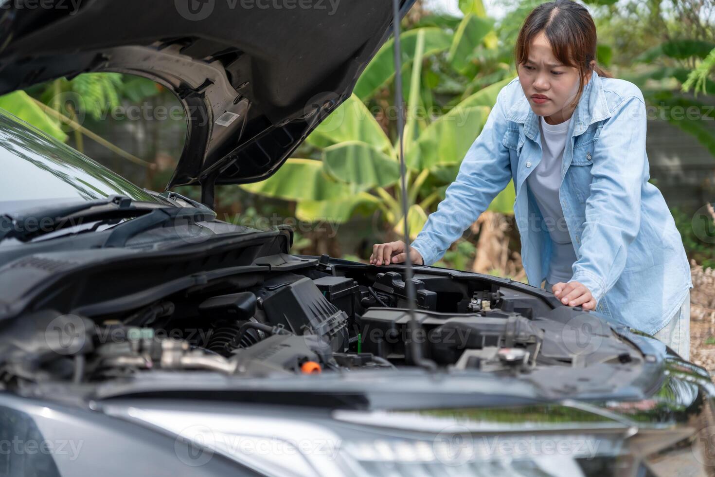 breakdown, broken car. Stress Woman look engine during car accident . Find garage to get car fixed during country tour, waiting for help, emergency. photo