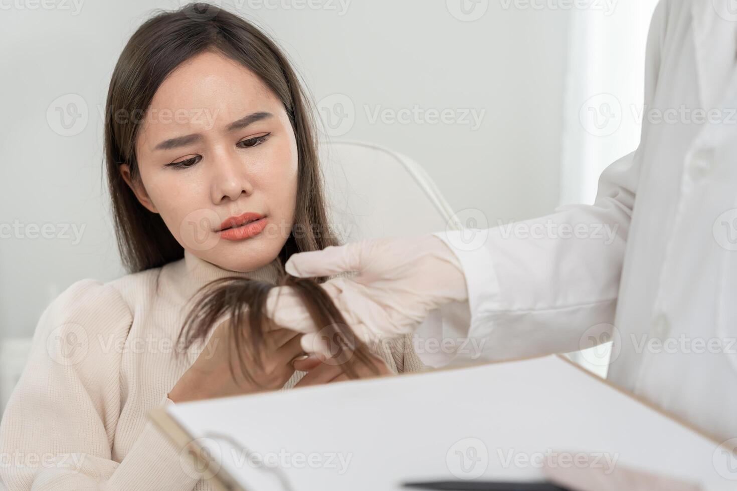 Specialist of hair recheck hair of Asian woman, damaged hair, hair loss, thinning problem, vitamin deficiency, baldness, postpartum, biotin, menstrual or endocrine disorders photo