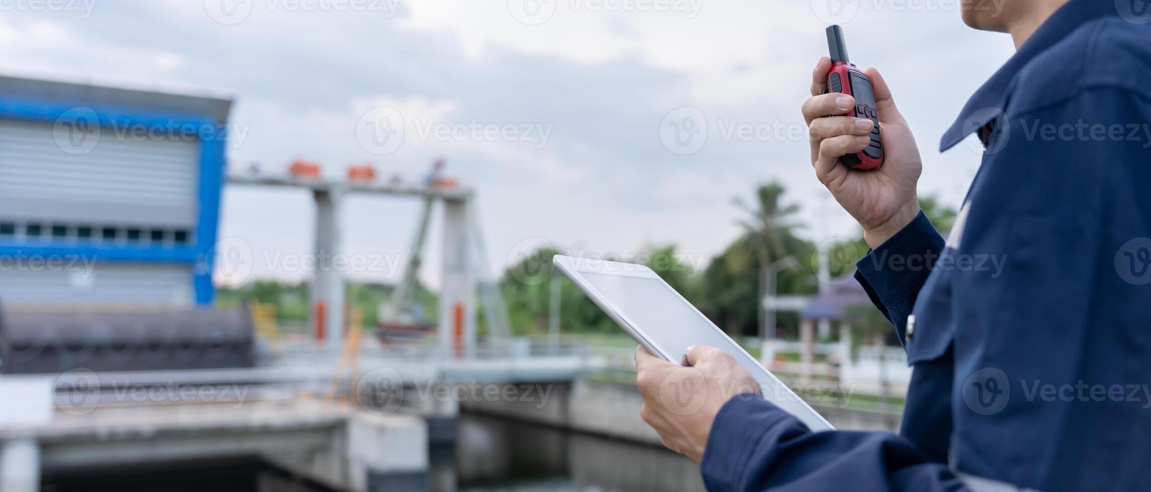 maintenance and inspector. Maintenance engineers are using walky talky to inform the results of inspection of buildings and structures. Irrigation engineers are explor sluice systems. photo
