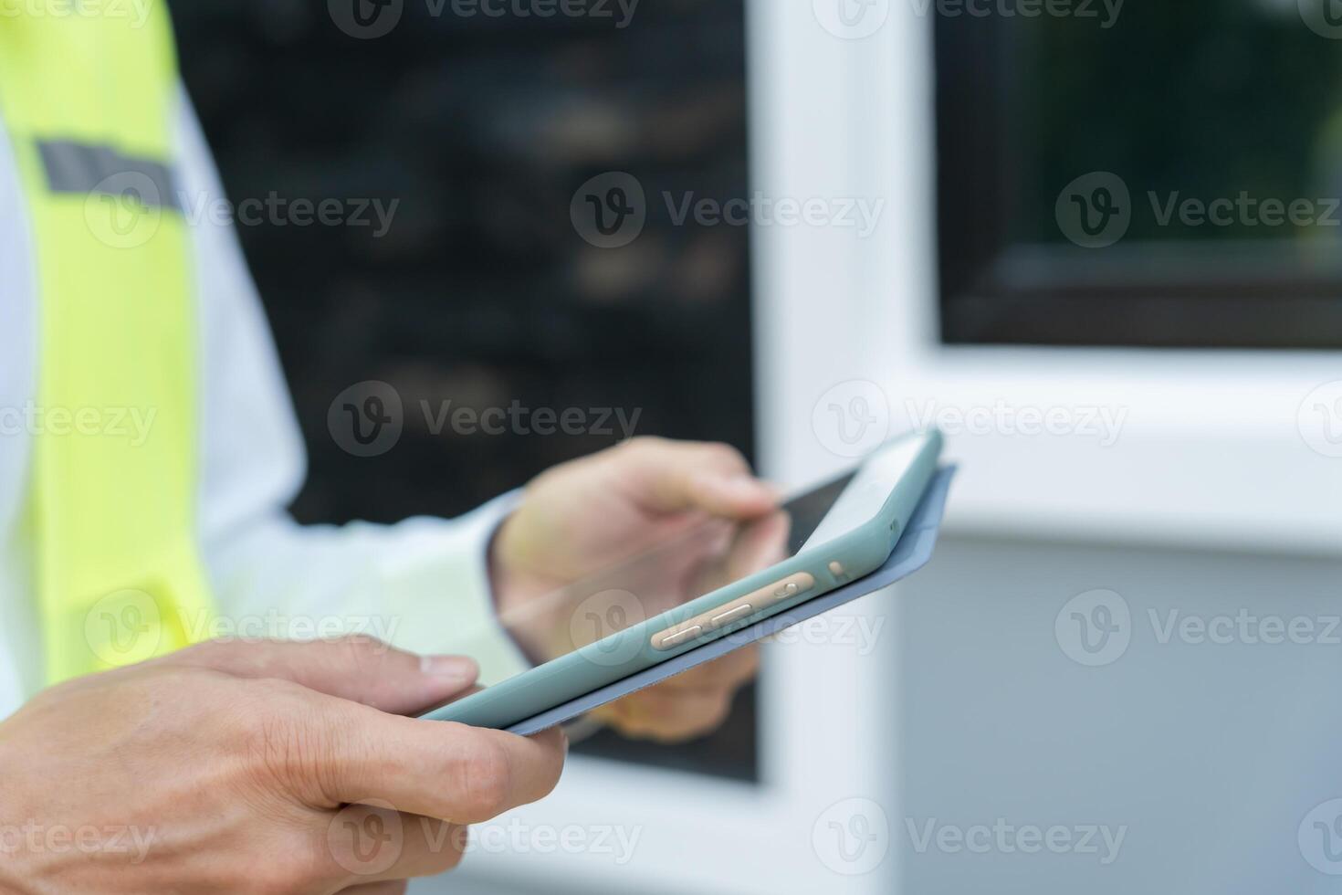 inspector or engineer is inspecting construction and quality assurance new house using a tablet. Engineers or architects or contactor work to build the house before handing it over to the homeowner. photo