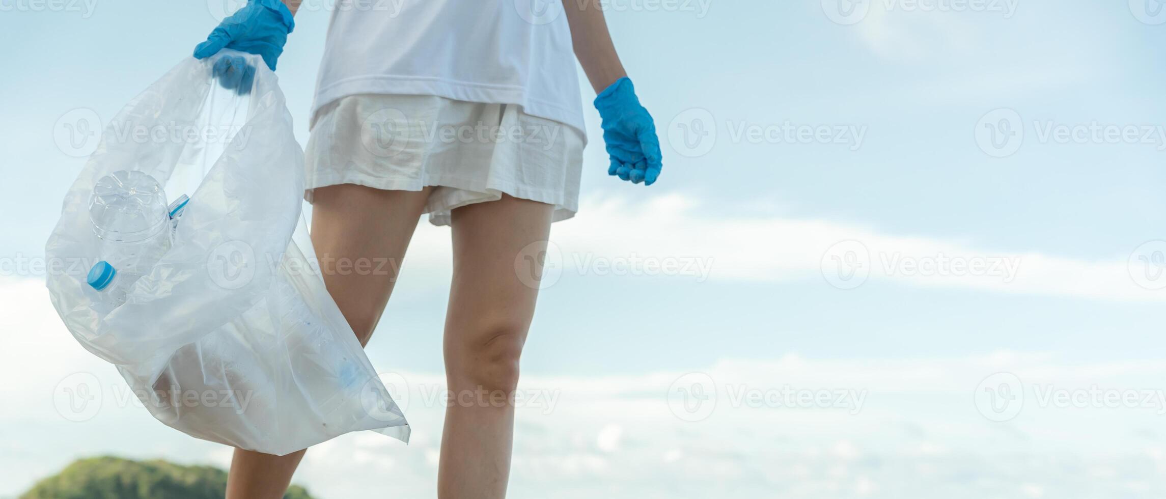 Save water, Volunteer pick up trash garbage at the beach and plastic bottles are difficult decompose prevent harm aquatic life. Earth, Environment, Greening planet, reduce global warming photo