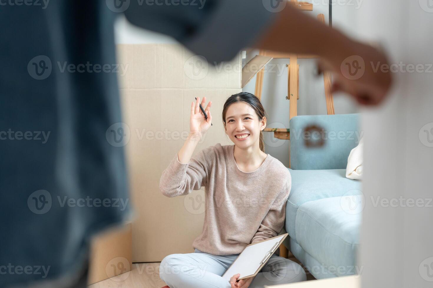 Moving house, relocation. Open the door found wife smile and play on new house, inside the room was a cardboard box contain personal belongings and furniture. move in the new apartment or home. photo
