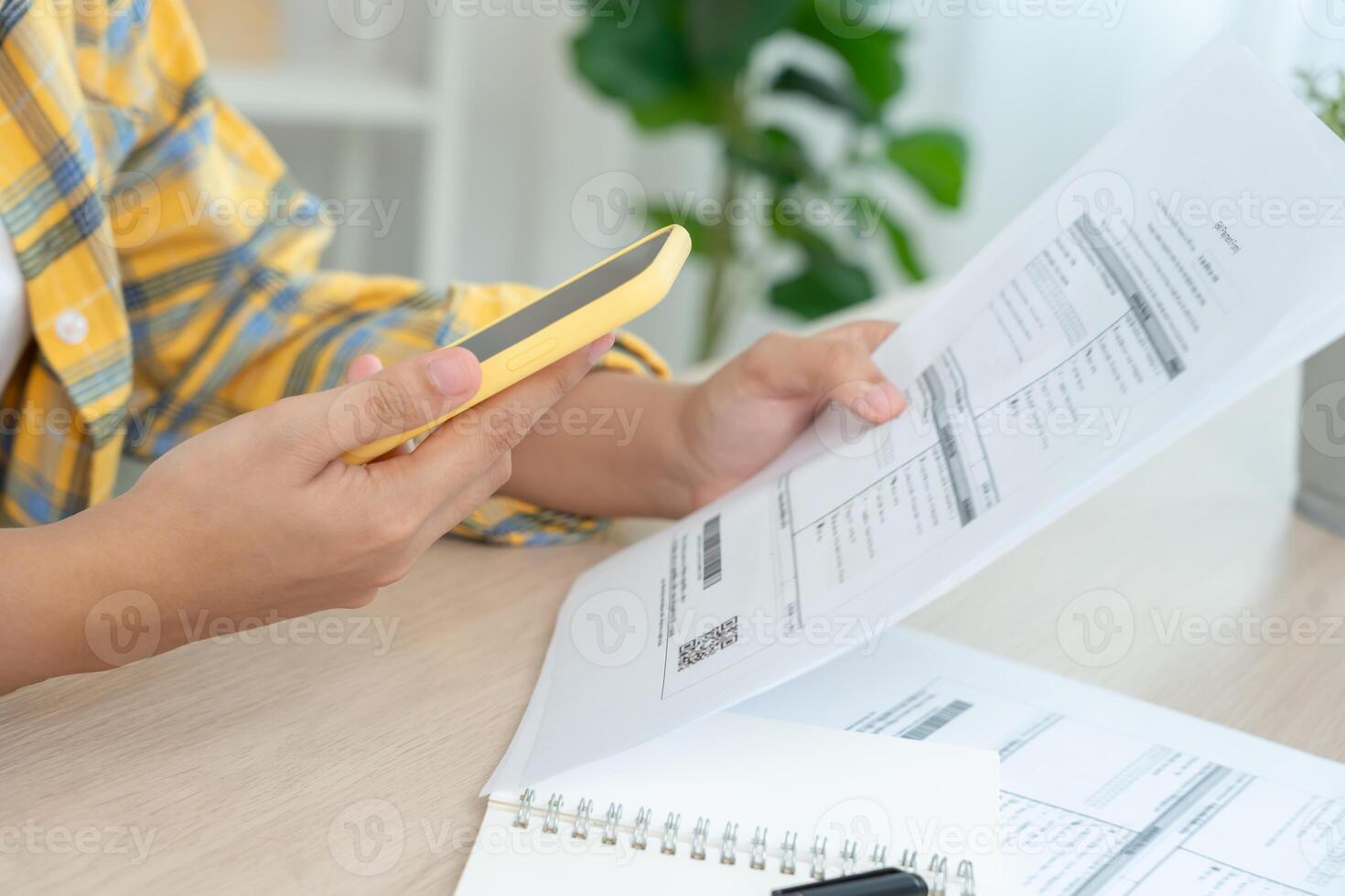 Modern woman use phone to scan barcode or QR codes to pay credit card bill after receive document invoice. payment, receive, paying electricity, digital payments without money, technology, scanning. photo
