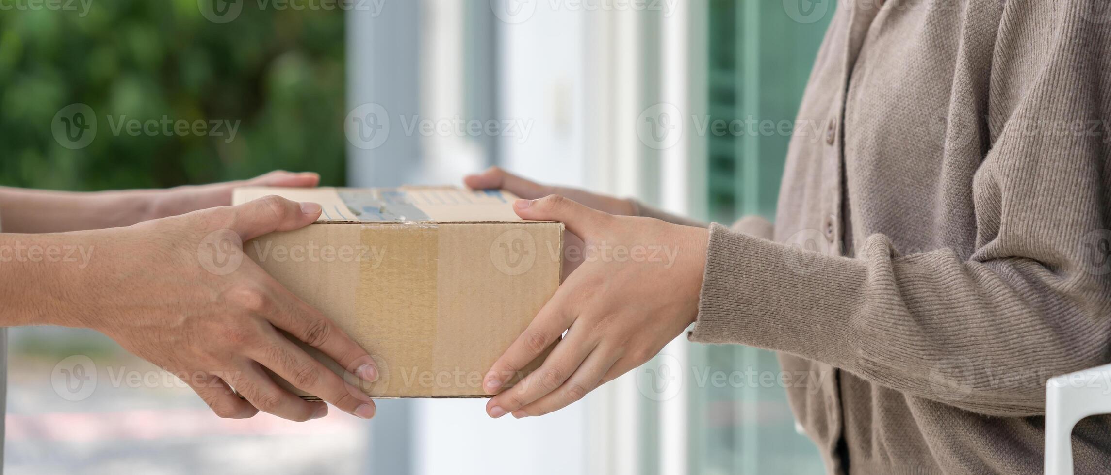 Happy smiling woman receives boxes parcel from courier in front house. Delivery man send deliver express. online shopping, paper containers, takeaway, delivery service. photo