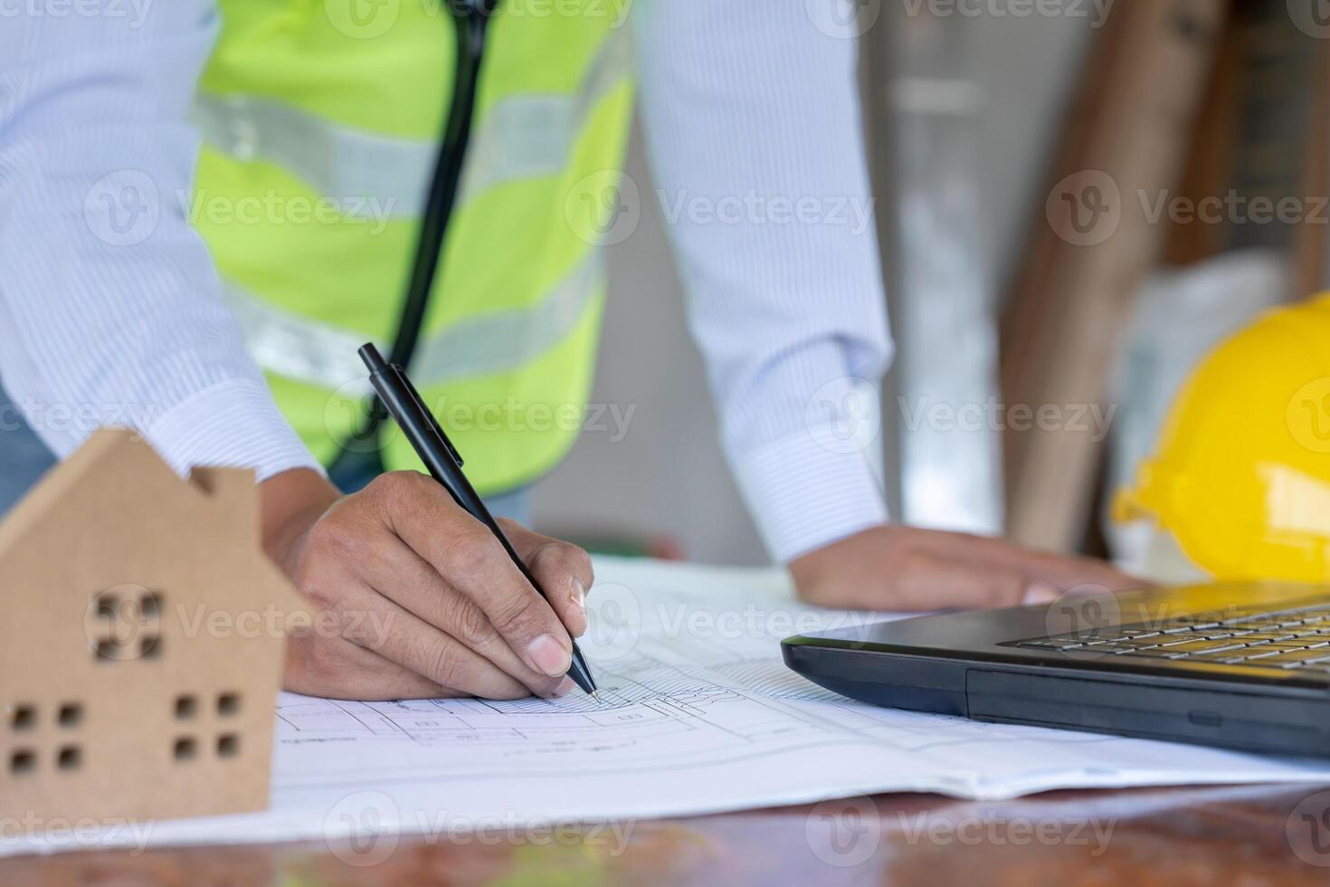 inspector is inspecting construction and quality assurance new house using a blue print. Engineer or architects or contactor work to build the house before handing it over to the homeowner, photo