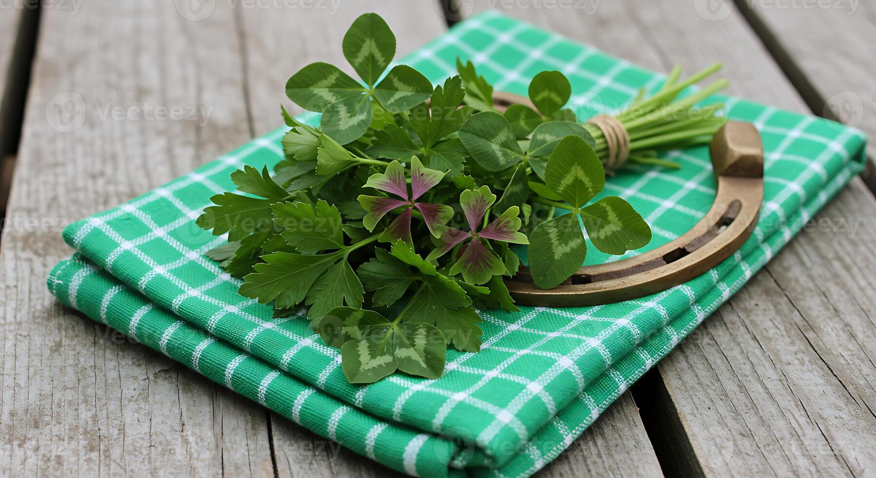 Lucky Clover and Horseshoe on Green Checkered Cloth on Wooden Surface photo
