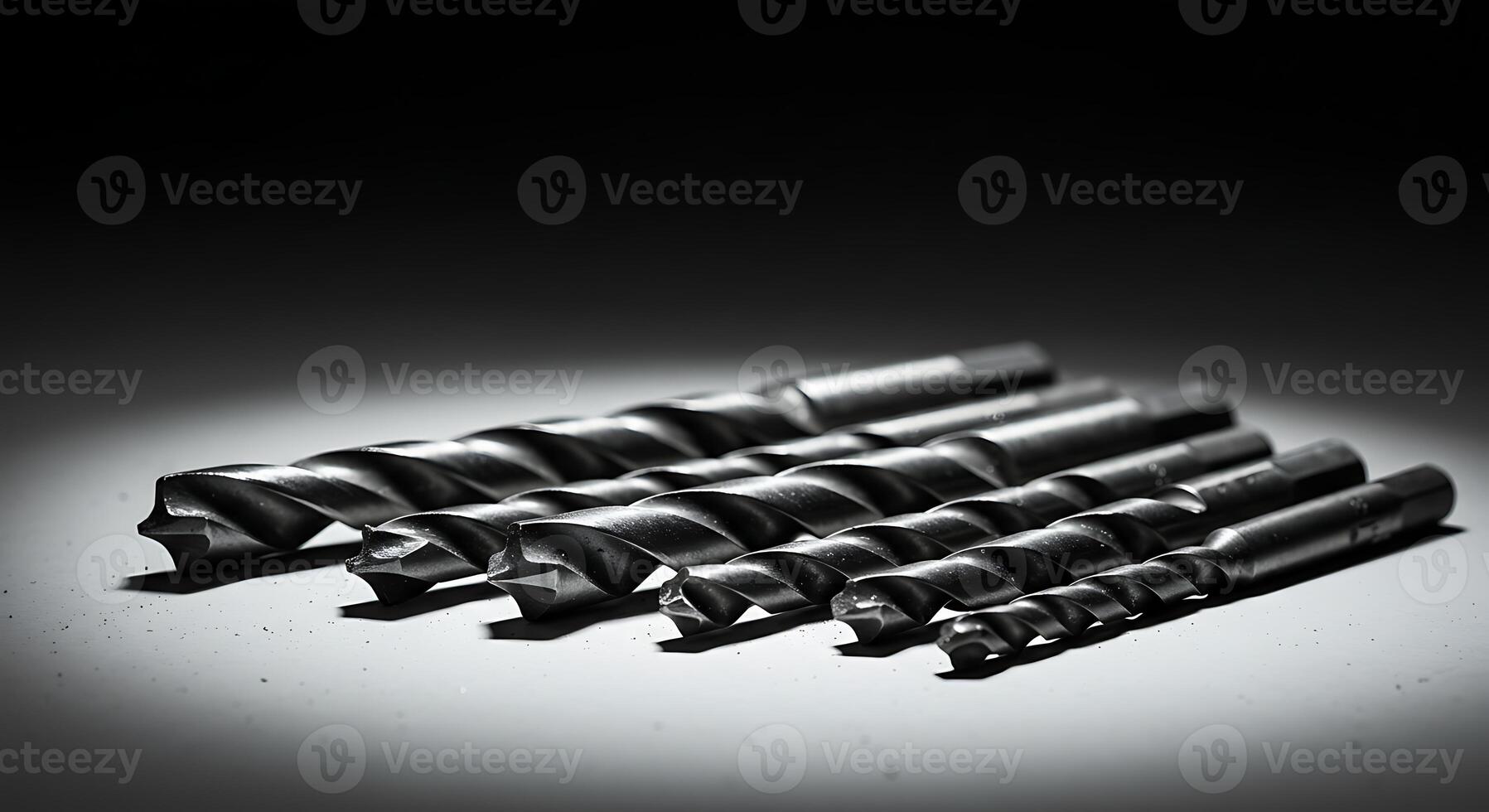 Drill Bits Set Lined Up on Surface in Workshop Lighting photo
