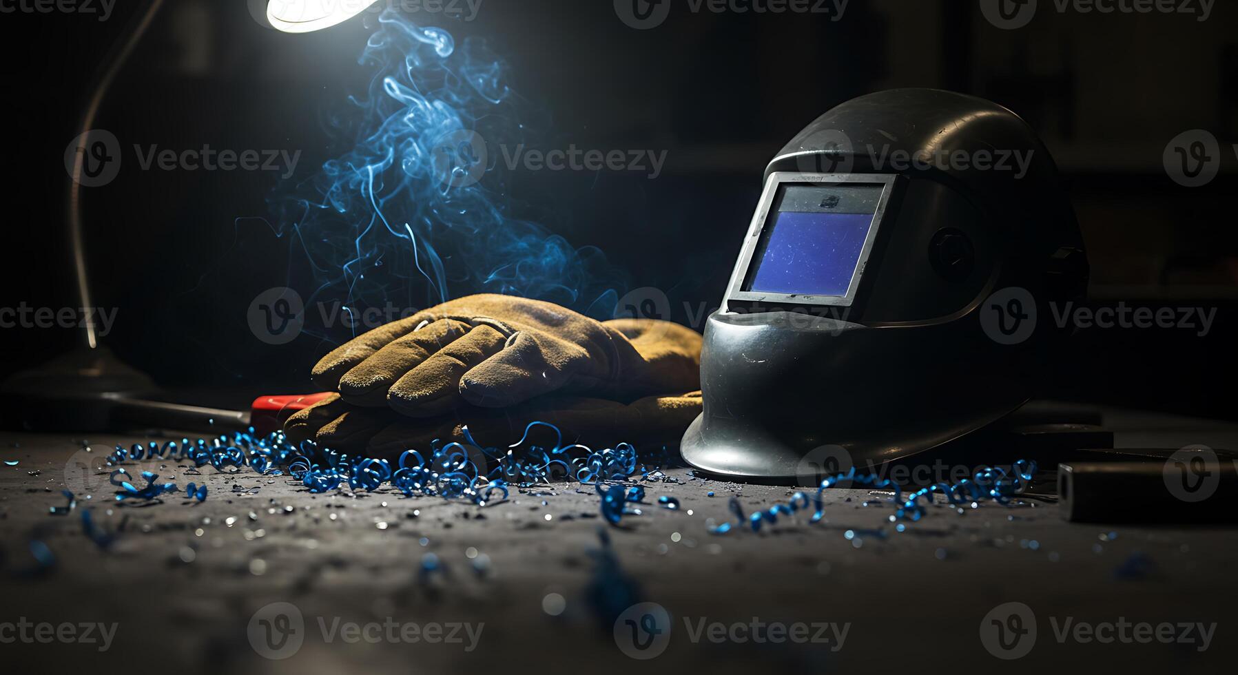 Welding Gear and Blue Metal Shavings on Dark Workshop Table photo