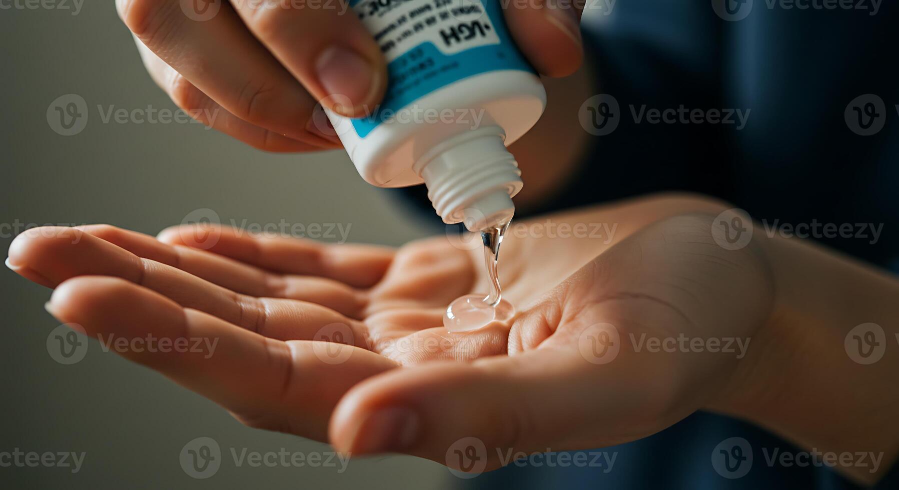 Applying Clear Liquid on Hand From Small Container for Hygiene photo