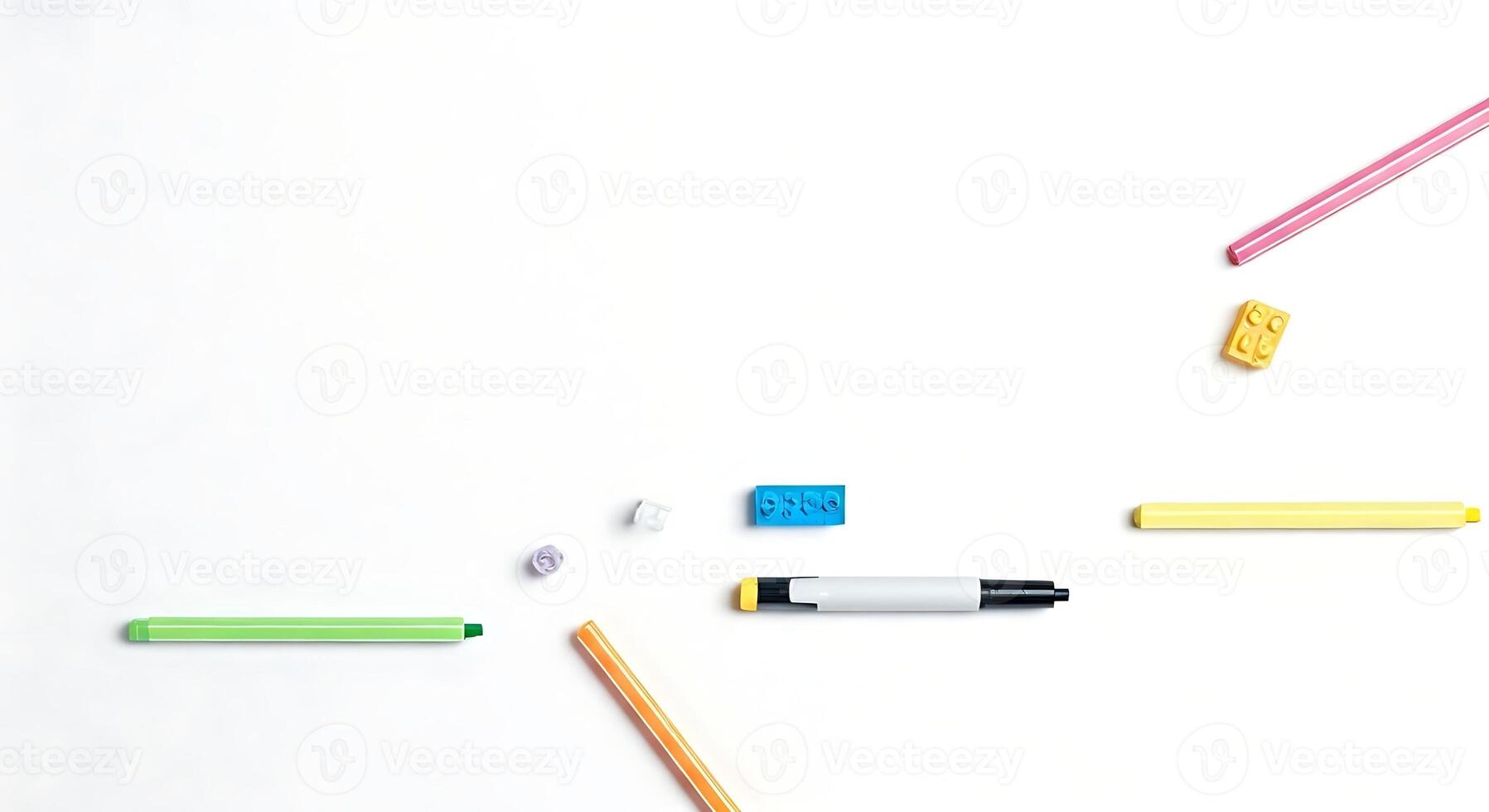 Colorful pencils and markers on a white surface photo