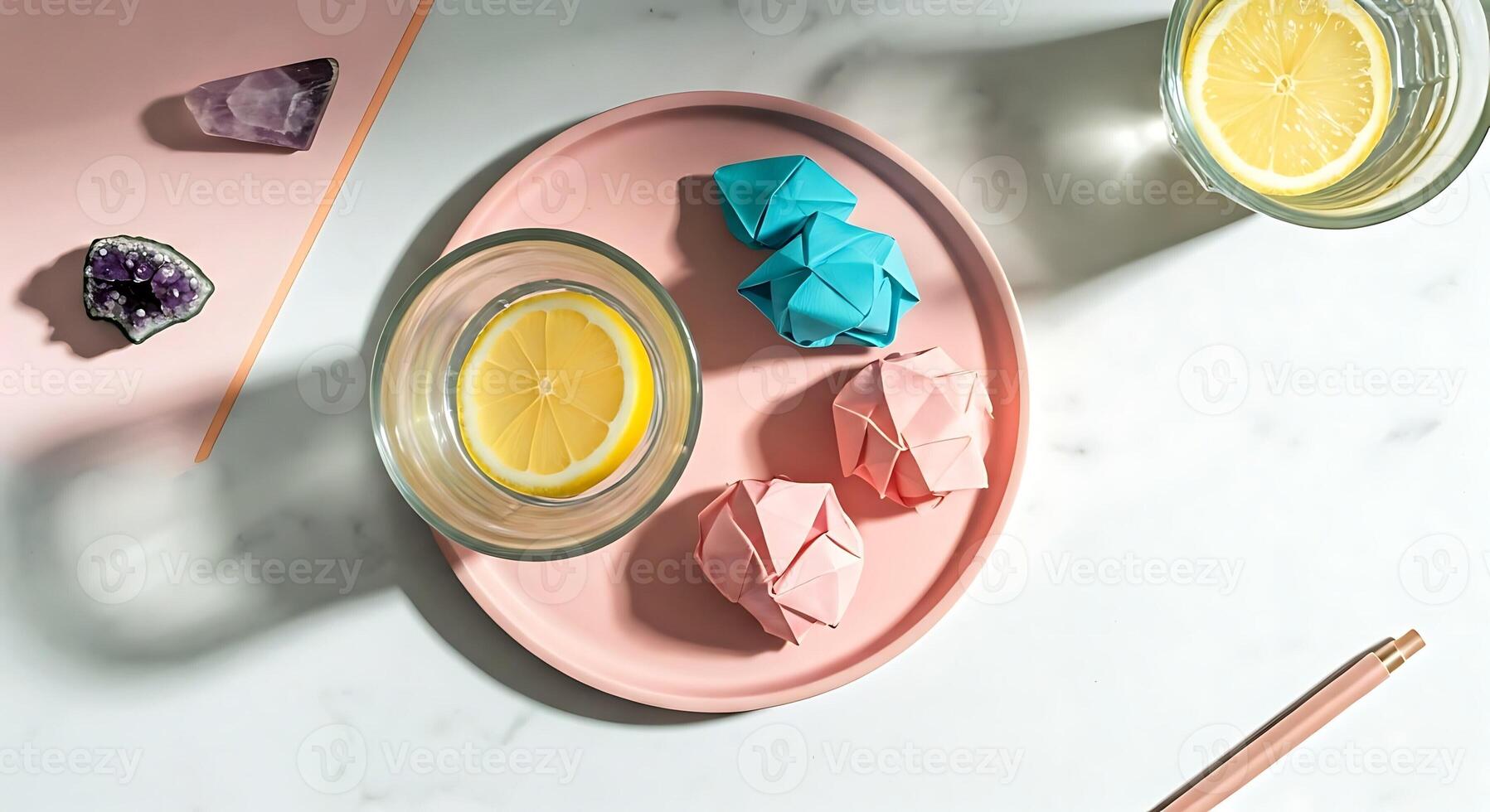 A pink plate with lemon slices and paper origami photo
