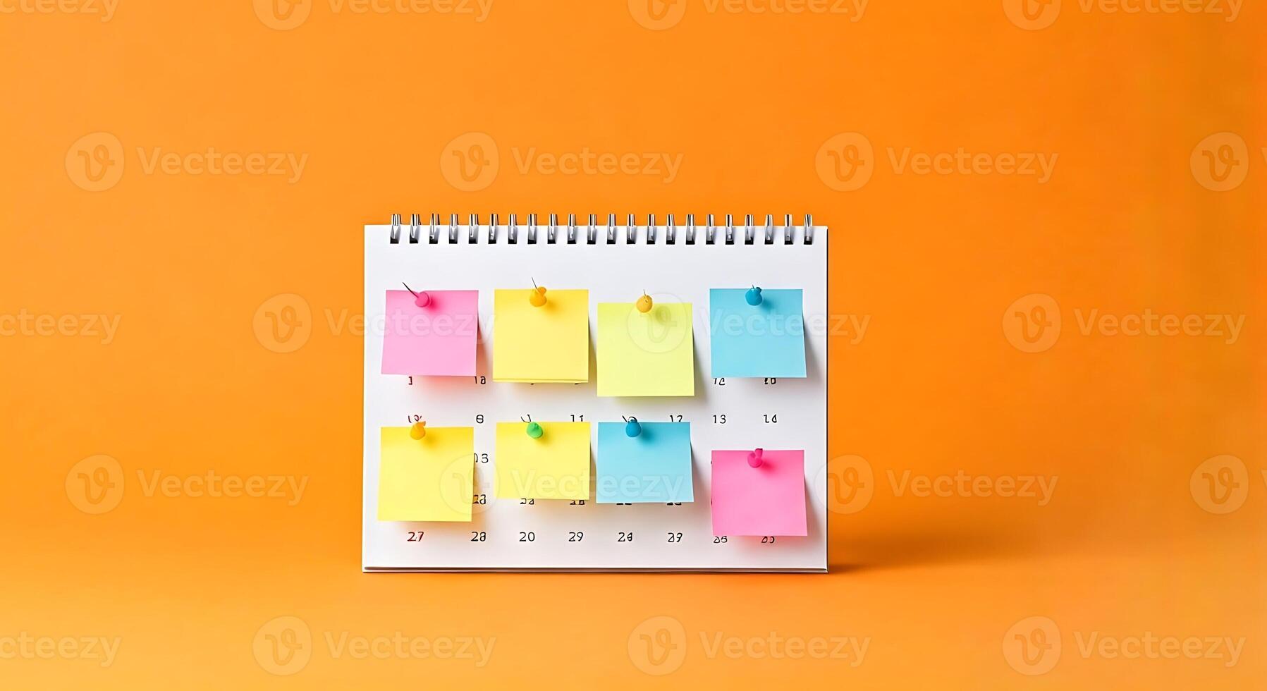 A calendar with sticky notes on it on an orange background photo