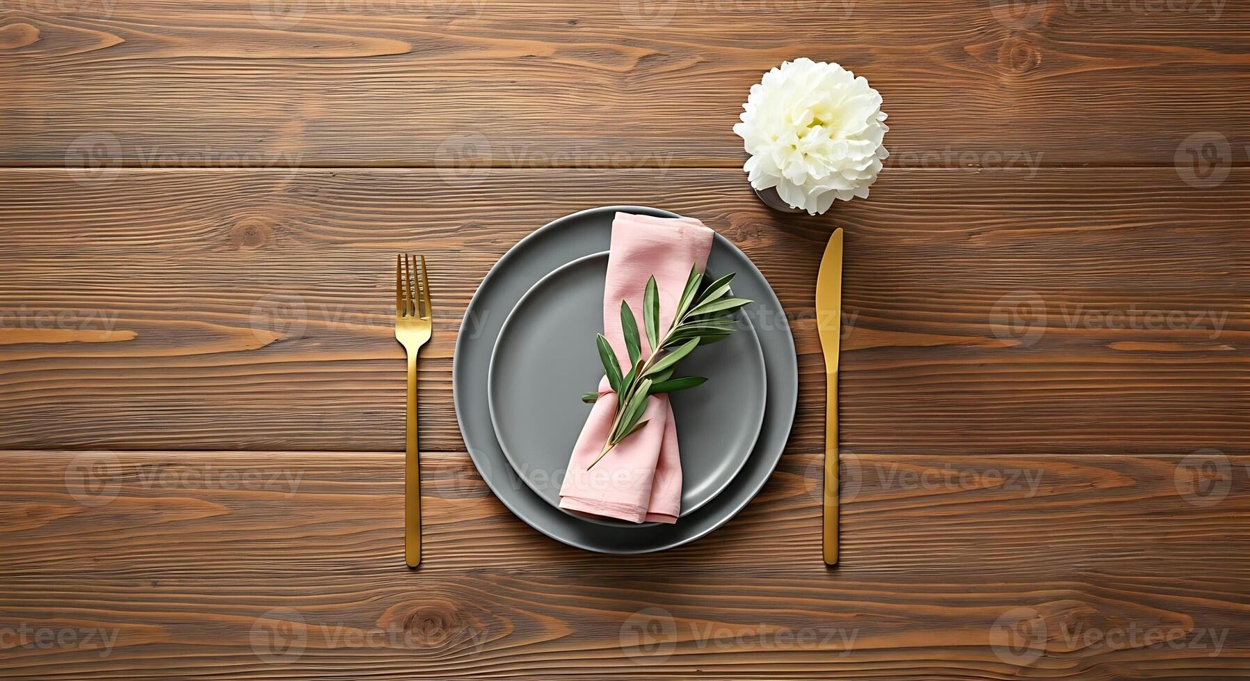 A plate with a napkin and a fork on a wooden table photo
