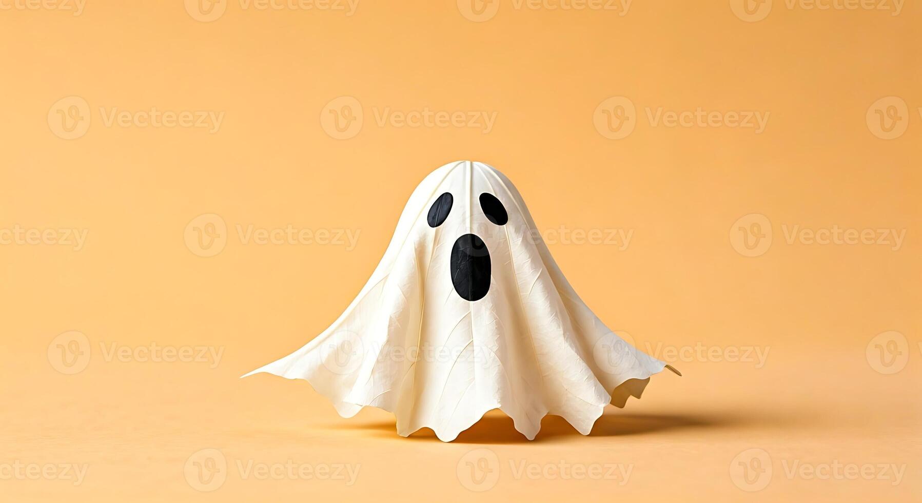 A paper ghost on a yellow background photo