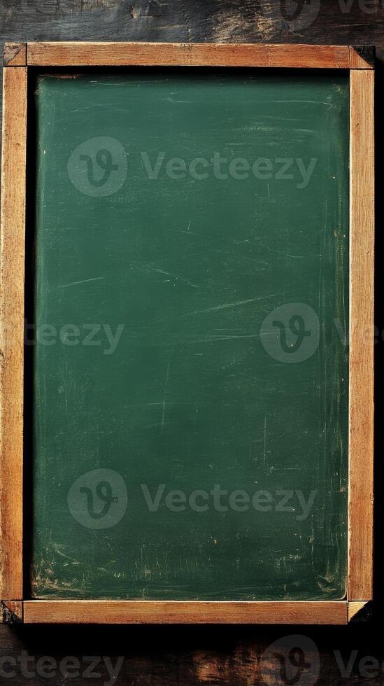 Blank green chalkboard with a wooden frame serves as a versatile surface for writing, teaching, or displaying information in educational environments photo
