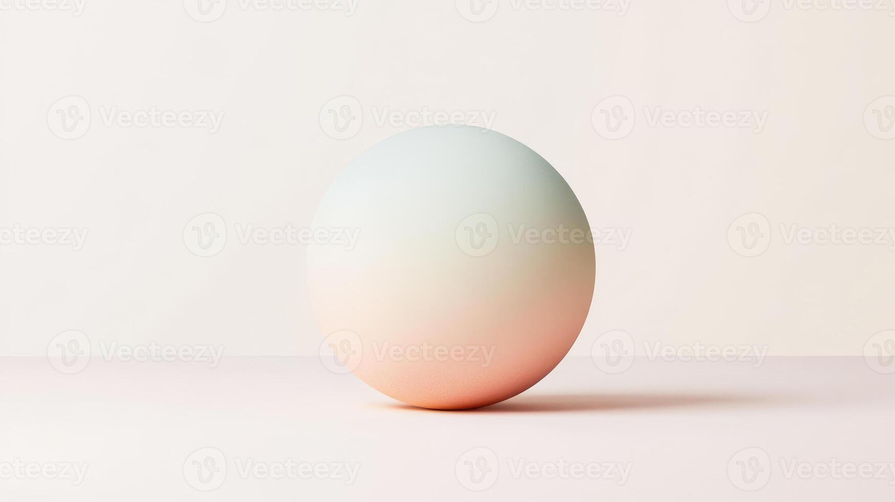 A singular smooth sphere featuring a gentle gradient of colors sits on a soft surface, illuminated by soft ambient light photo