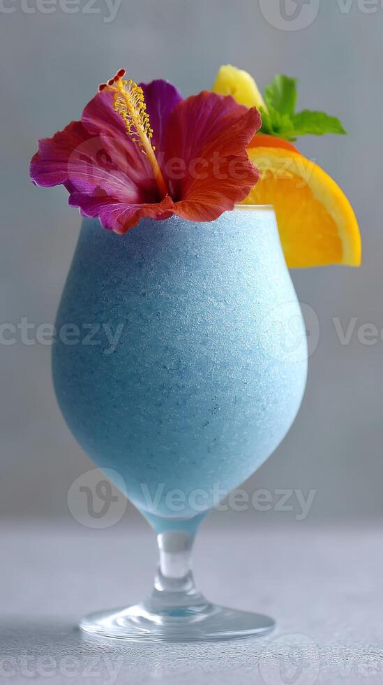 A refreshing blue curacao cocktail featuring a combination of tropical colors, garnished with a hibiscus flower and slices of citrus fruit photo