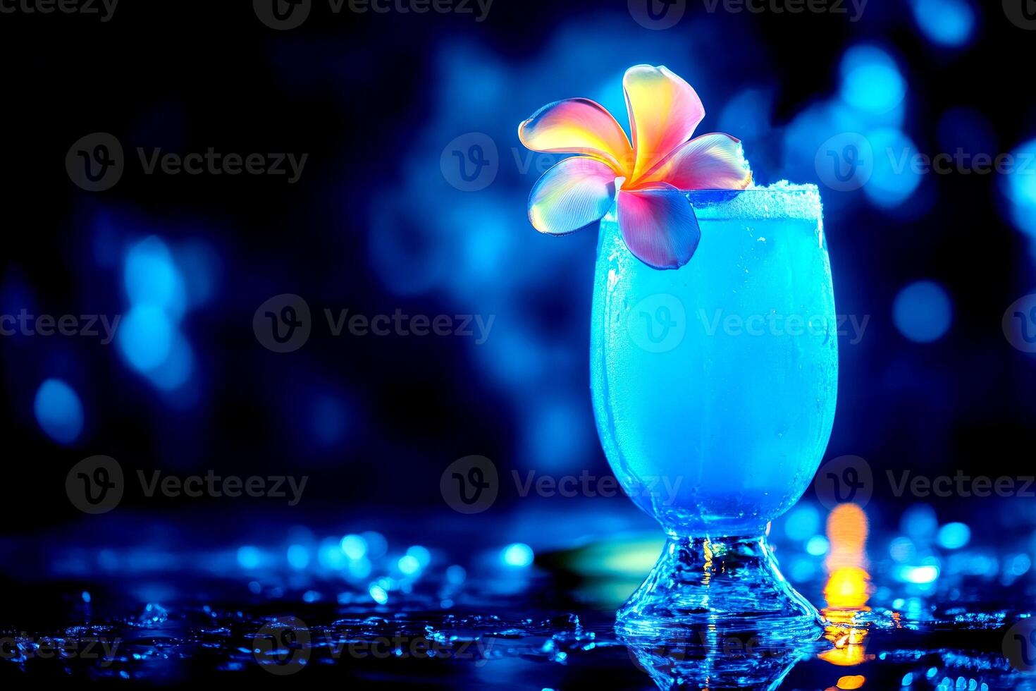 A captivating blue cocktail adorned with a vibrant flower sits on a shiny surface, glowing amidst an enchanting dark backdrop photo
