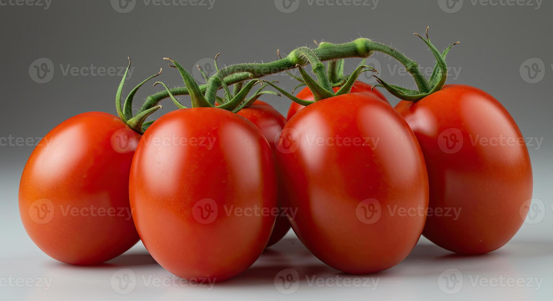 Fresh ripe tomatoes on the vine, a close-up shot against a neutral background photo