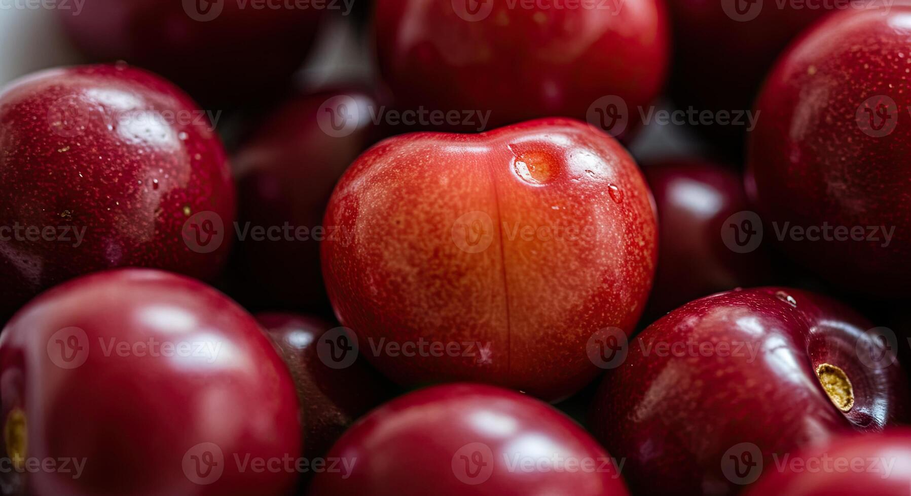 Macro shot of ripe red plums showcasing their vibrant color and smooth texture photo
