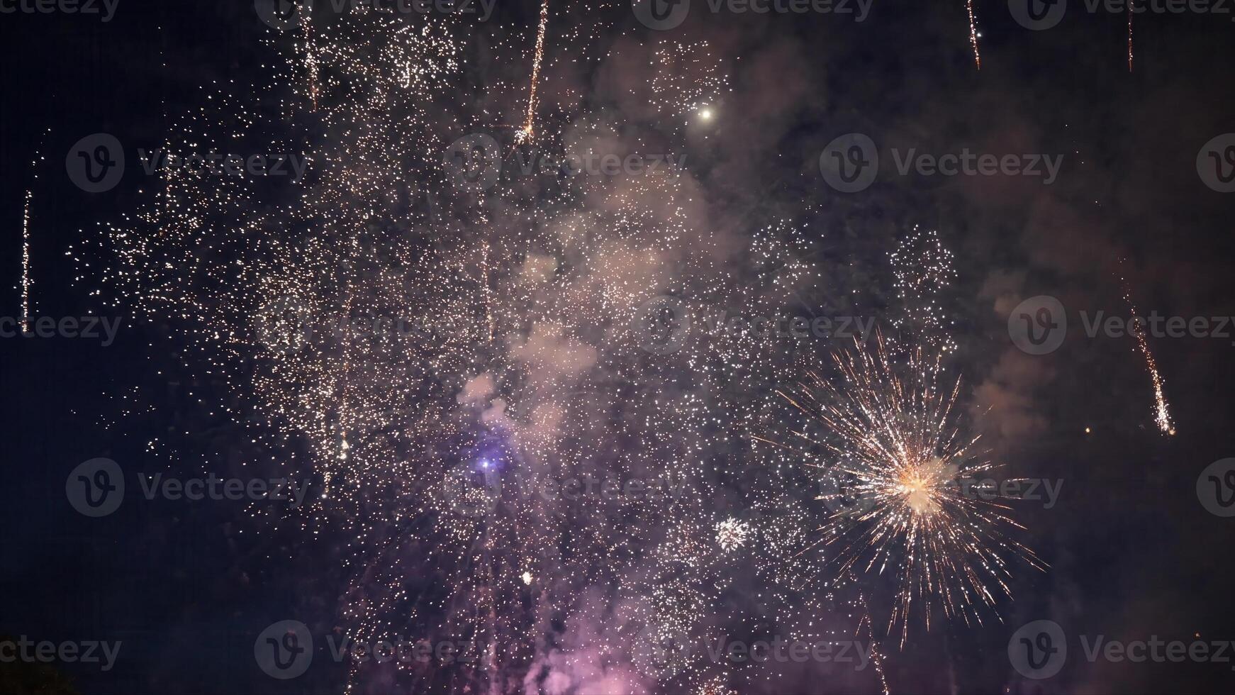 Several Fireworks exploding in the night sky during a celebration photo