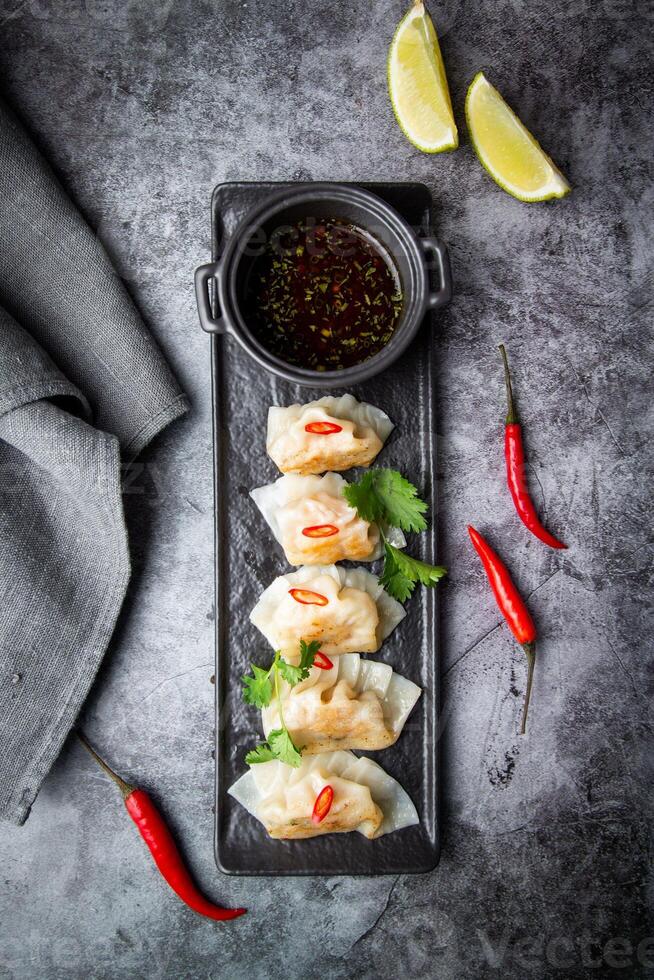 gyoza with shrimps with spicy soy sauce side view photo