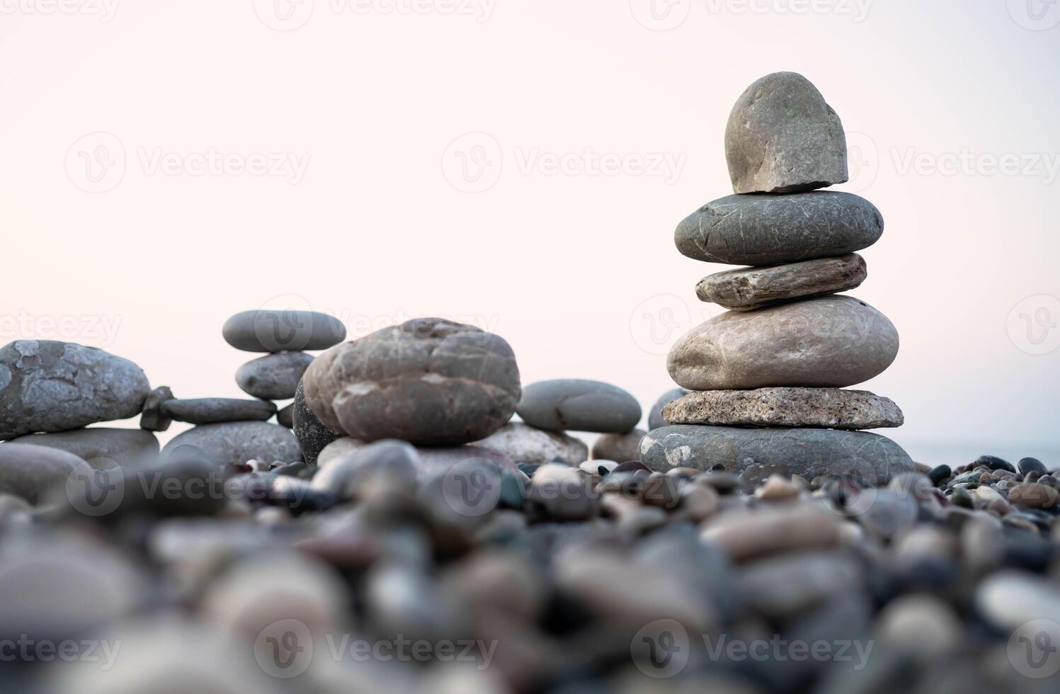 Stacked stones on a pebbled beach creating a tranquil and balanced natural scene photo