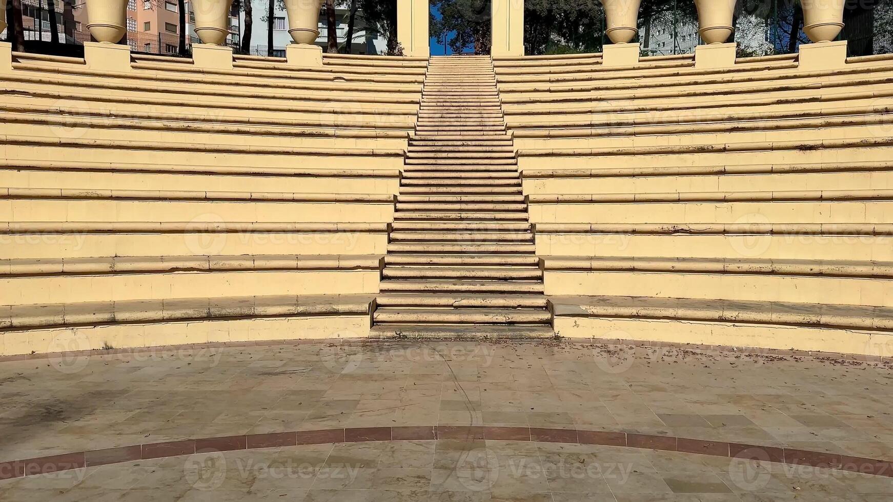 An incredibly beautiful amphitheater featuring welldefined steps, decorative artistic columns, and more photo