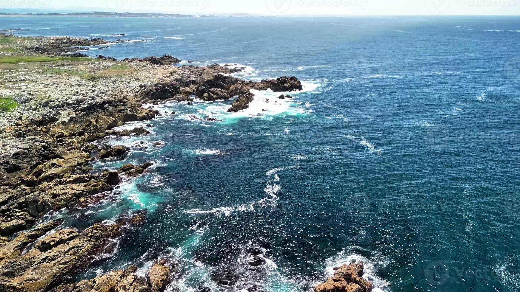 Aerial capture shows the stunning rocky coastline merging with vibrant, crystal clear turquoise waters photo