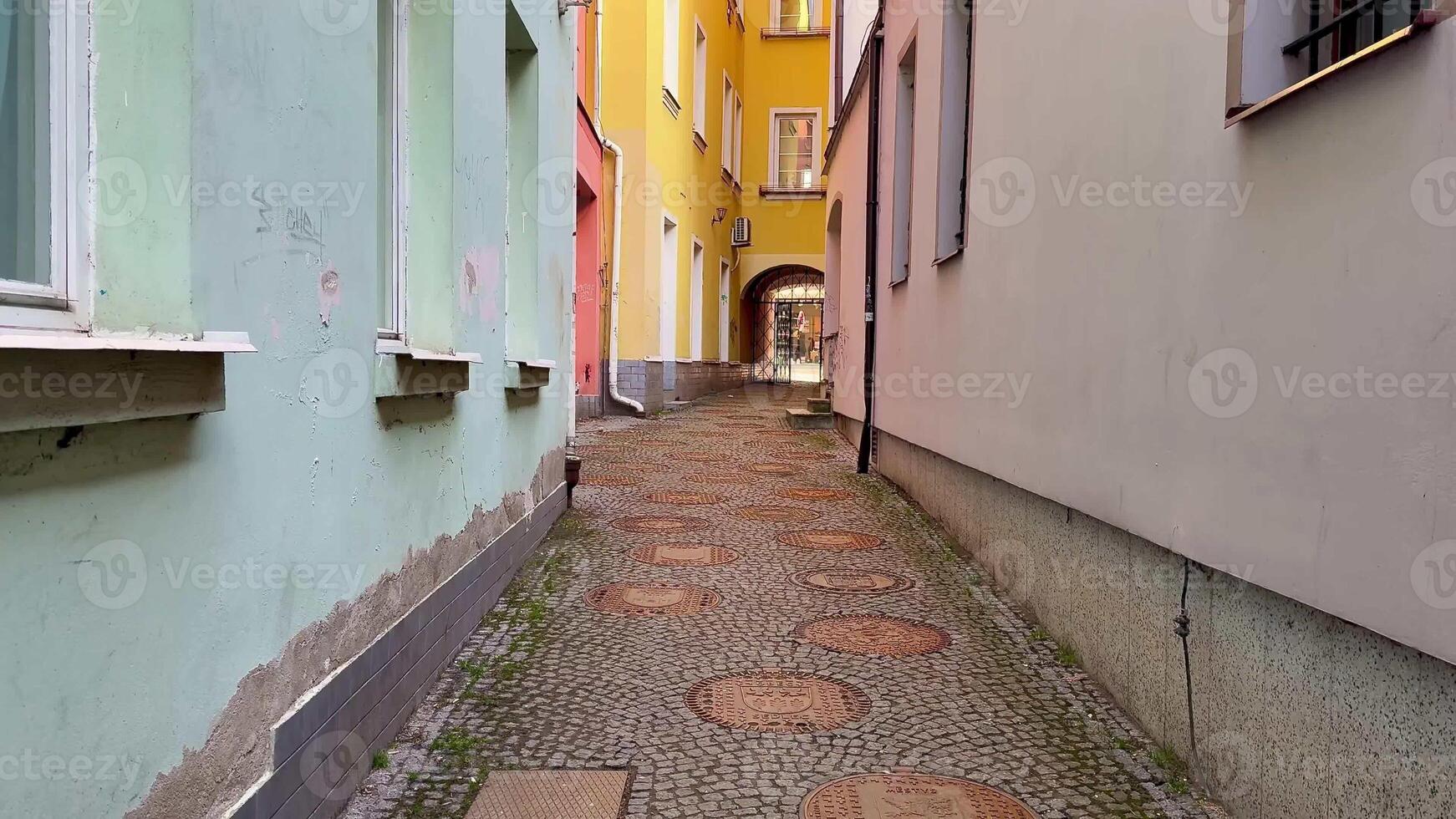 Explore a picturesque alleyway with colorful buildings and charming cobblestone streets inviting adventure photo