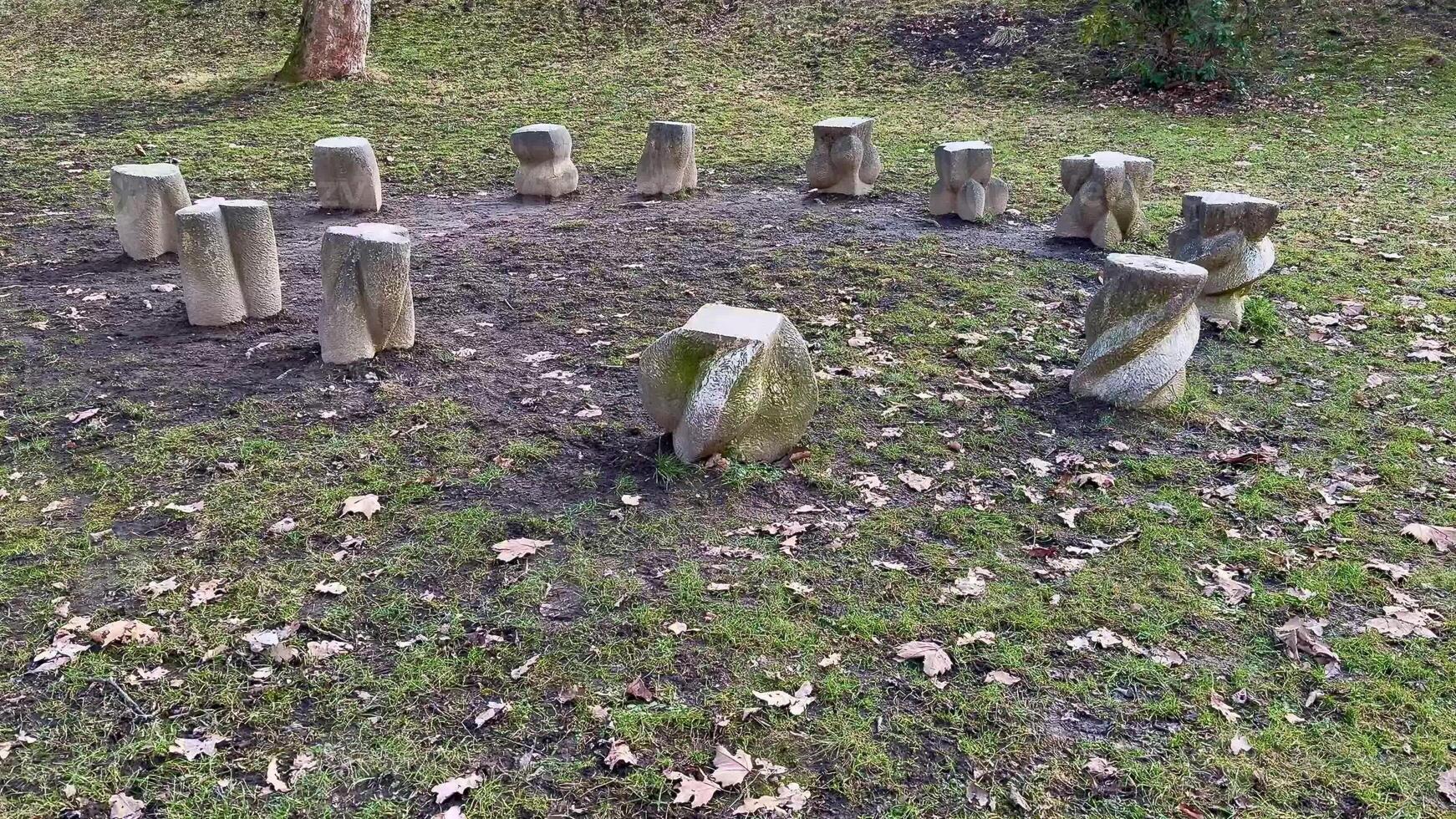 A serene stone circle amidst green grass and autumn leaves evokes deep ancient traditions and rituals photo