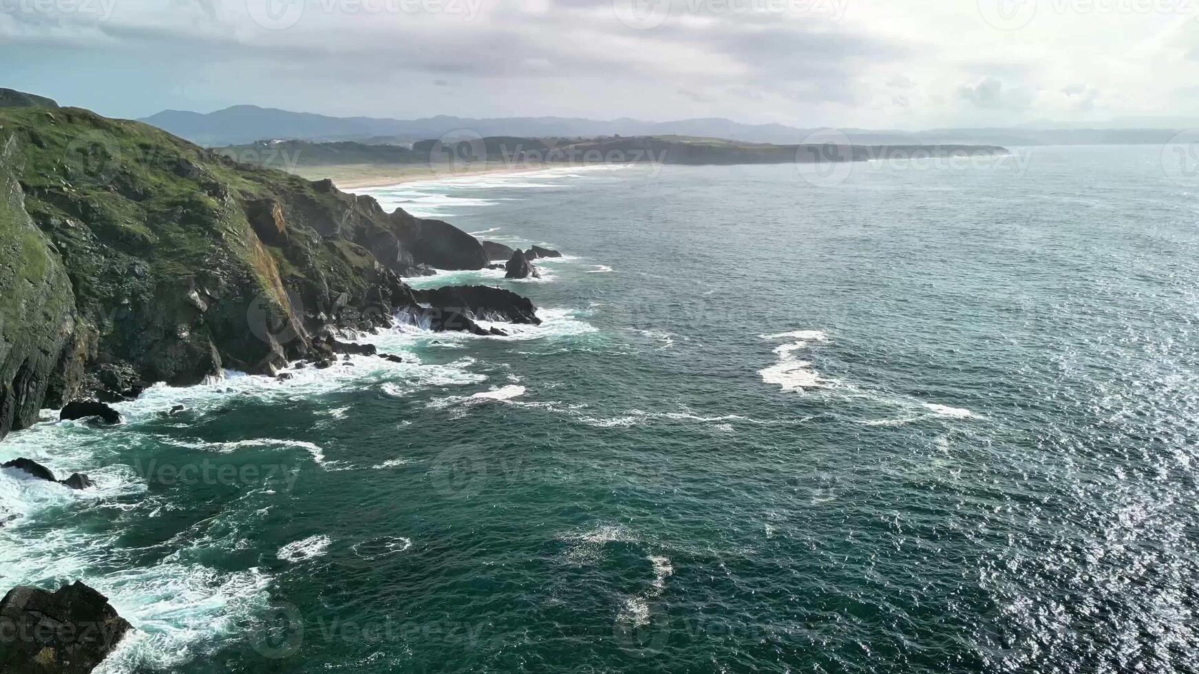 Experience breathtaking coastal landscapes filled with crashing waves and lush verdant cliffs reaching skyward photo