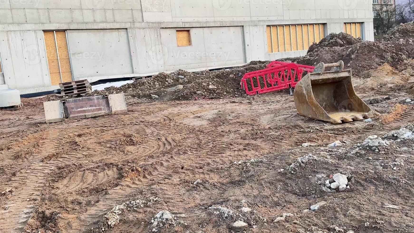 A construction site displaying various earthmoving machinery and a rough, unfinished piece of terrain photo