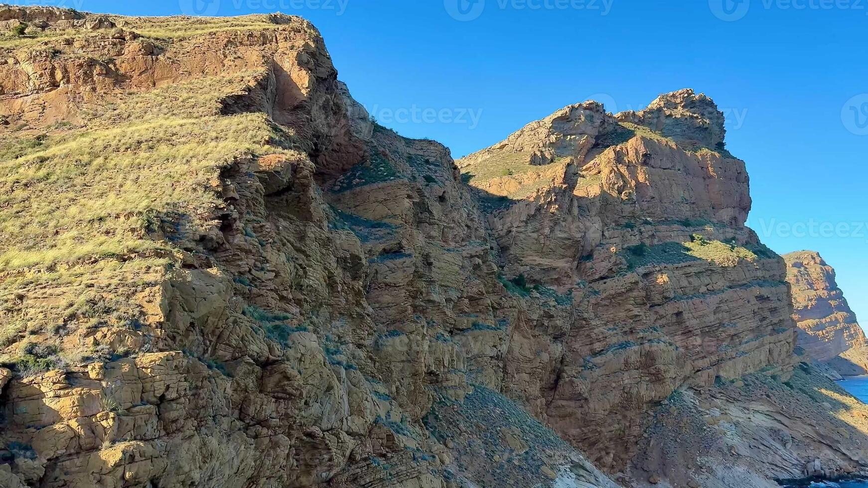 The breathtaking cliffs that line the coast reveal stunning unique geological formations and vibrant colors photo