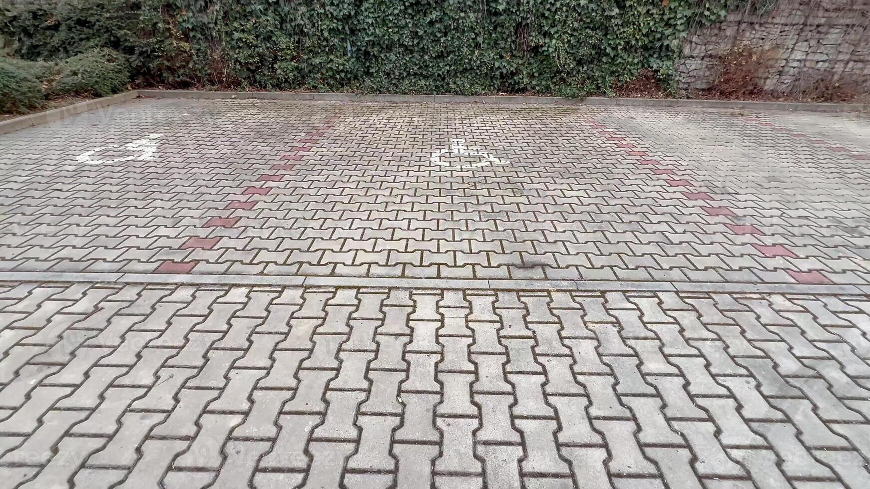 The paved parking area is designed with clear symbols indicating accessibility features and designated spaces photo