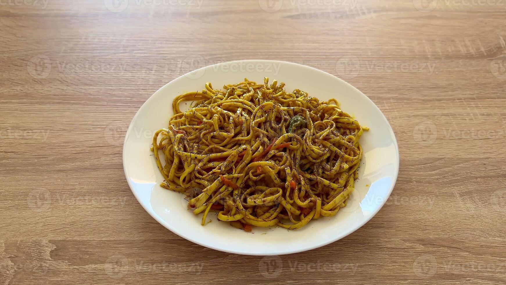 Enjoy a spicy noodle bowl, garnished with colorful fresh vegetables, perfect for quick, satisfying meals anytime photo