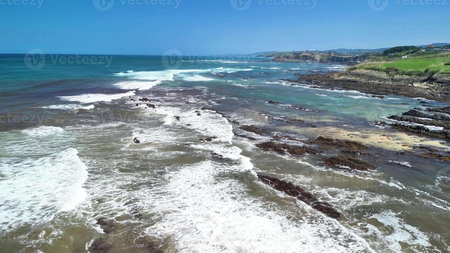 Stunning aerial footage beautifully showcasing the dynamic waves and rugged coastlines of the ocean photo