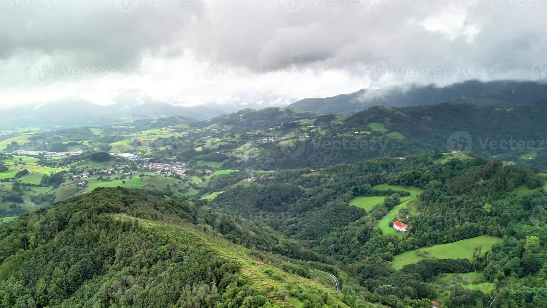 A stunning aerial view of picturesque landscapes with lush green hills, serene valleys, and dramatic clouds photo