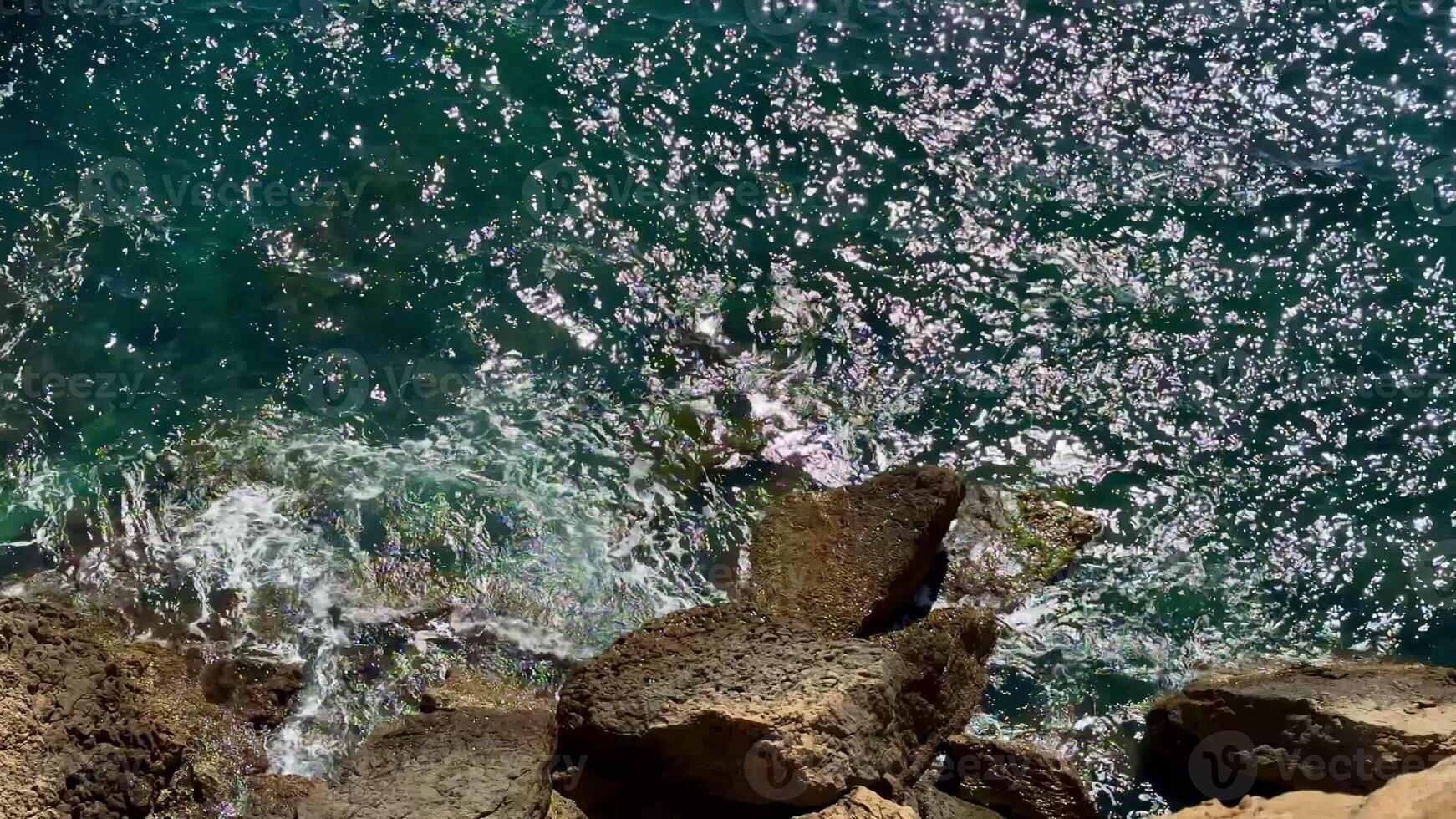 A stunning and picturesque view of ocean waves sparkling and shimmering beautifully under the bright sunlight photo
