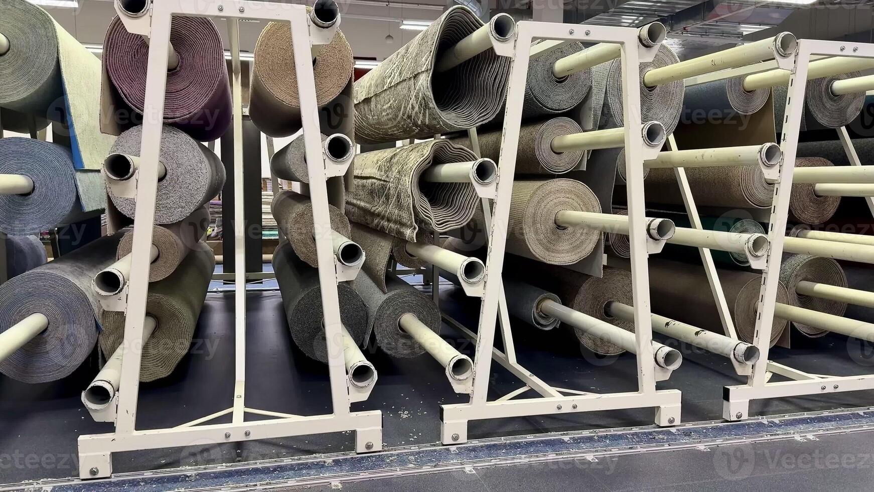 Organized storage of various media rolls on racks, showcasing material diversity in a comprehensive layout. photo