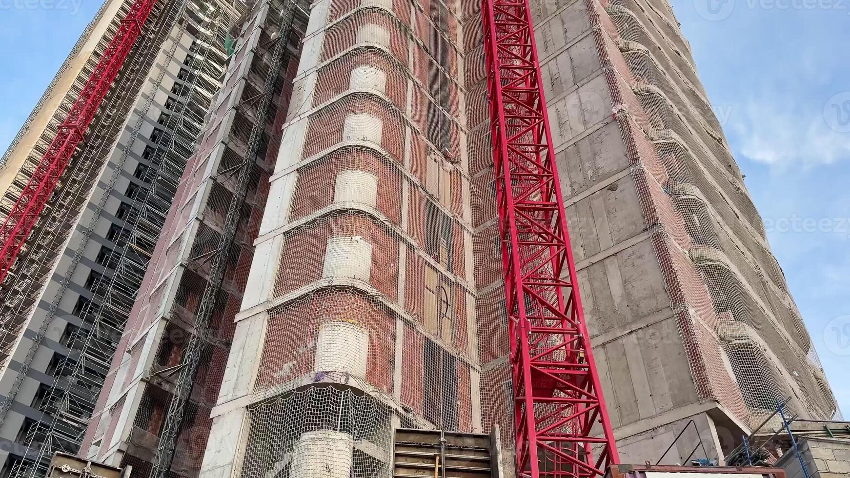 A stunning view of a modern high-rise building under construction, showcasing structural design and cranes. photo