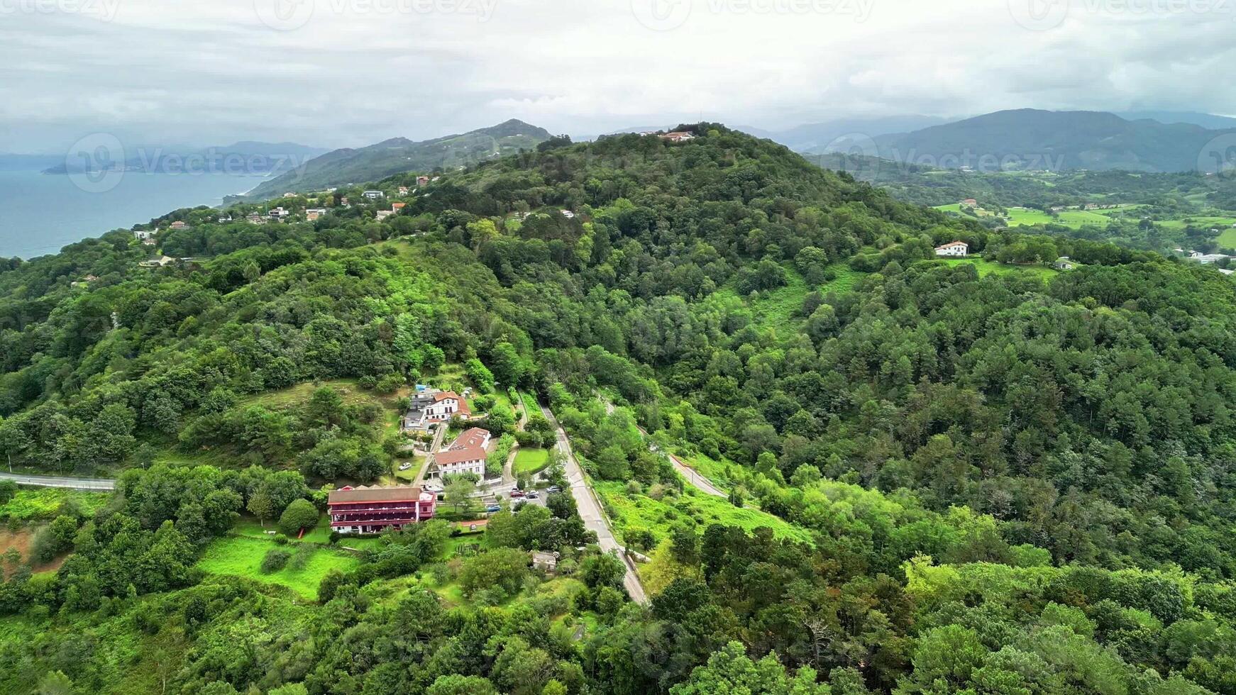 Stunning aerial view showcasing vibrant lush greenery, picturesque hills, and breathtaking coastal scenery photo