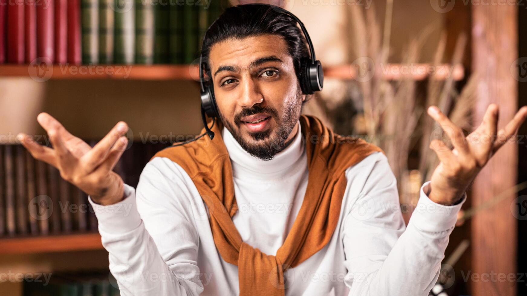 E-Teaching. Young Arab Teacher Teaching Online Talking To Camera Wearing Headset Having Virtual Lecture Sitting Indoors. Modern Education, Distance Tutoring And Learning Concept photo