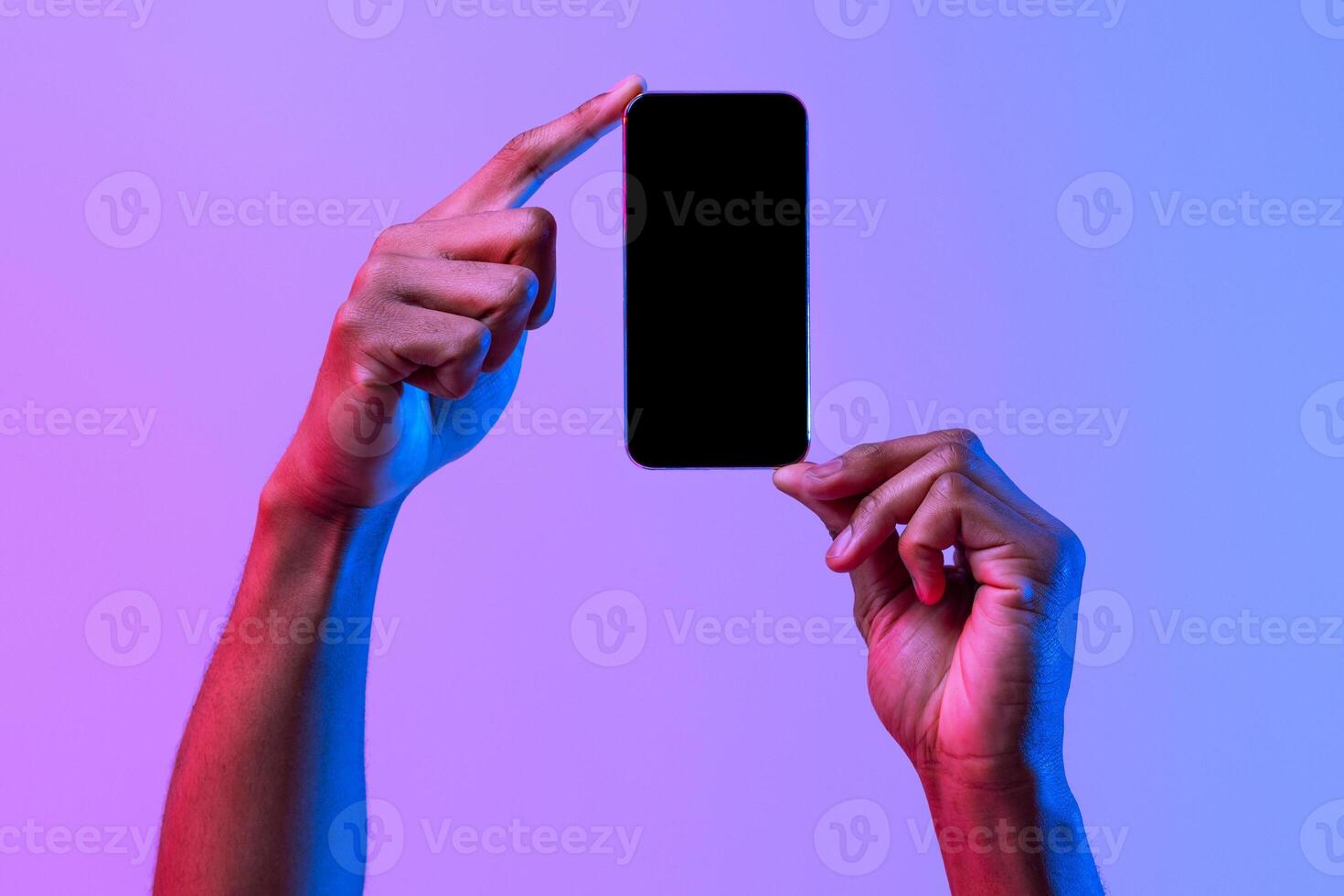 Two African American Male Hands Holding Smartphone With Black Screen Over Purple Neon Background, Unrecognizable Man Demonstating Copy Space For Website Or App Design, Mockup Image photo