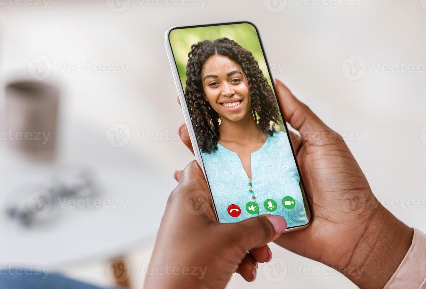 Pov of black person holding cell phone in hand calling online and talking with woman looking on mobile screen using smartphone videochat app, staying at home, closeup view, selective focus photo