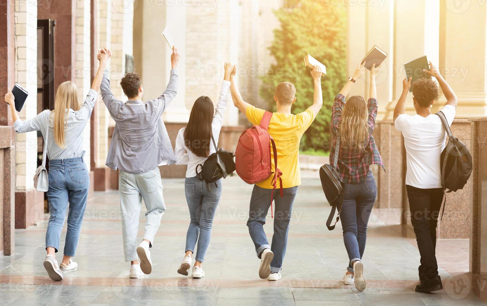 Pass exams. Students walking in college campus after the last test photo