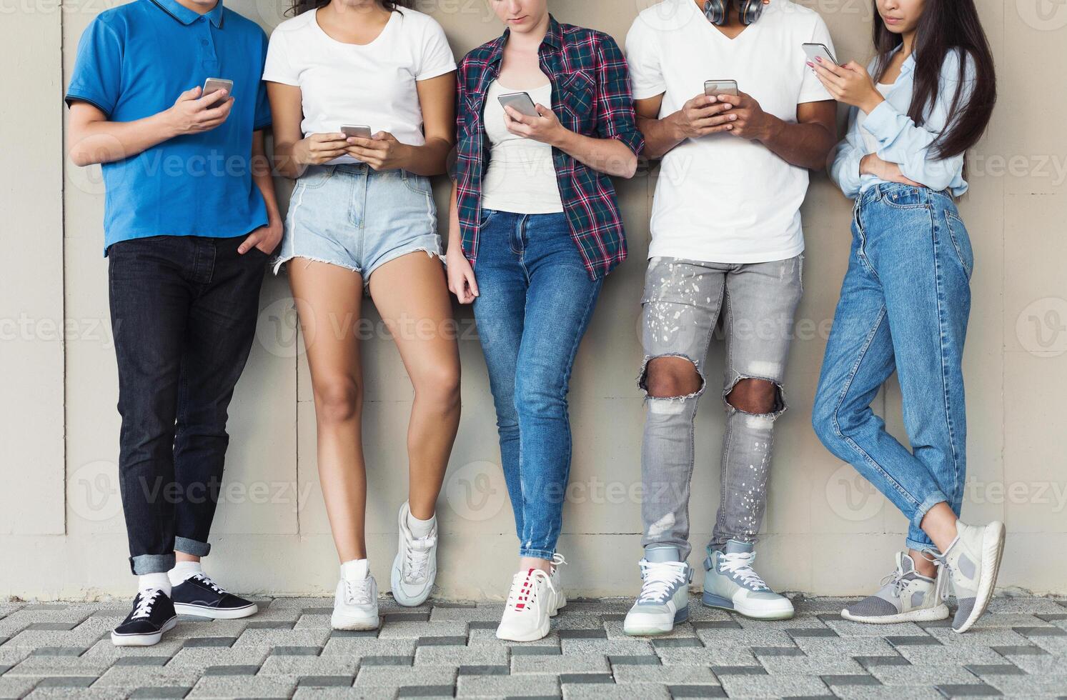 Group of Multicultural Friends Using Smartphones on Urban Background, free space photo
