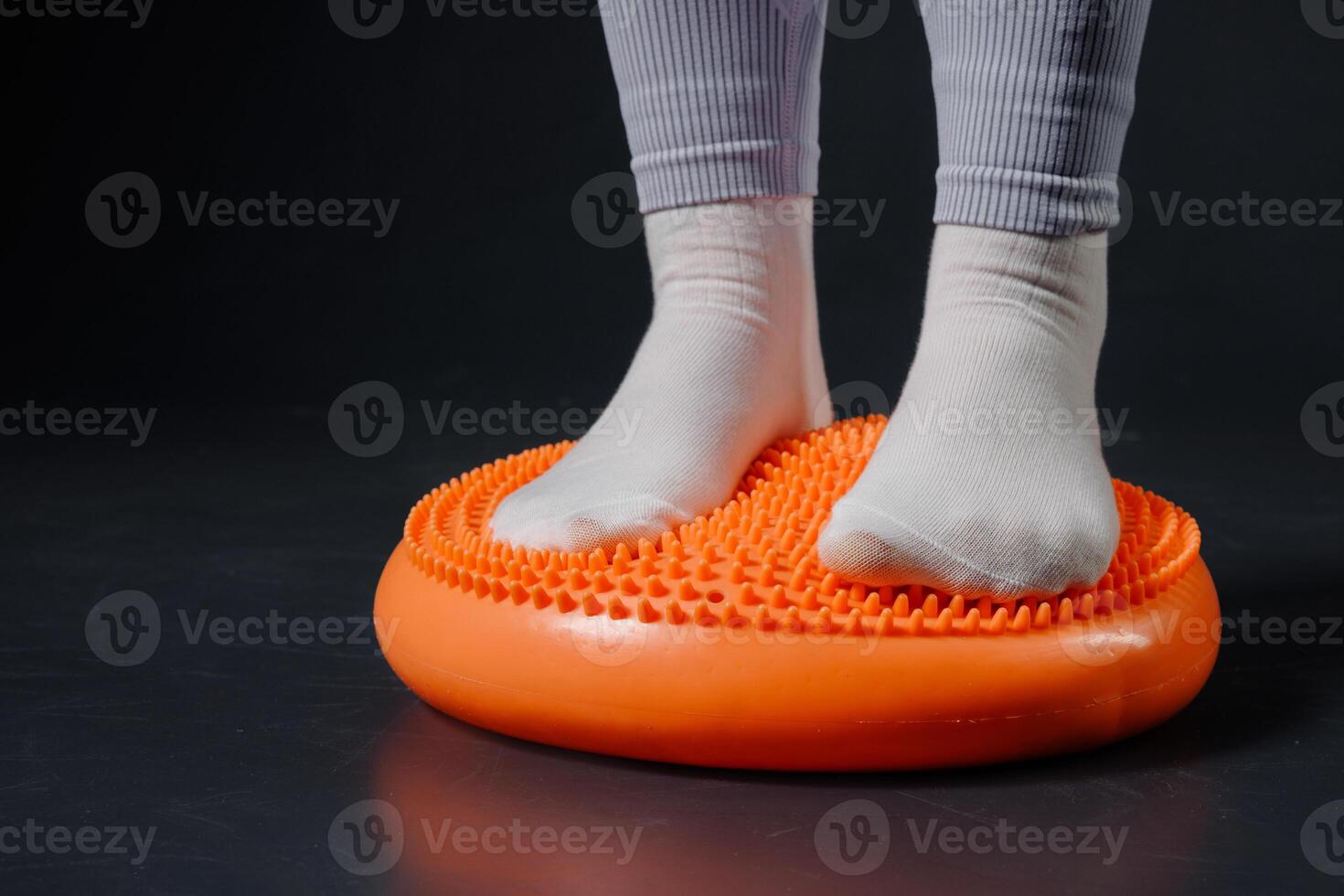 Child Standing on Spiky Balance Cushion for Foot Therapy, Coordination Training, and Sensory Stimulation photo