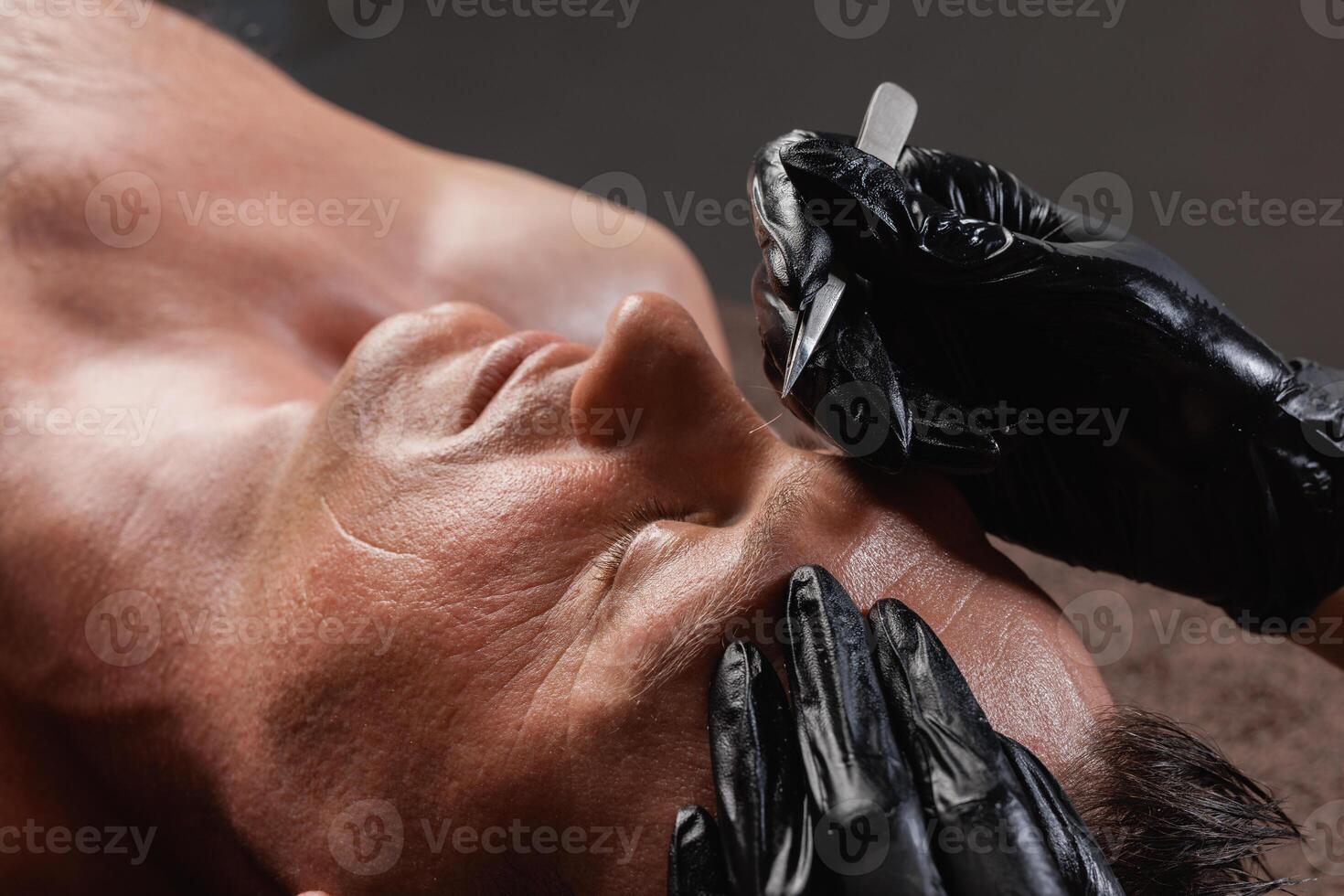Professional Male Facial Treatment with Tweezers, Spa Skincare Procedure, Close Up, Black Gloves photo