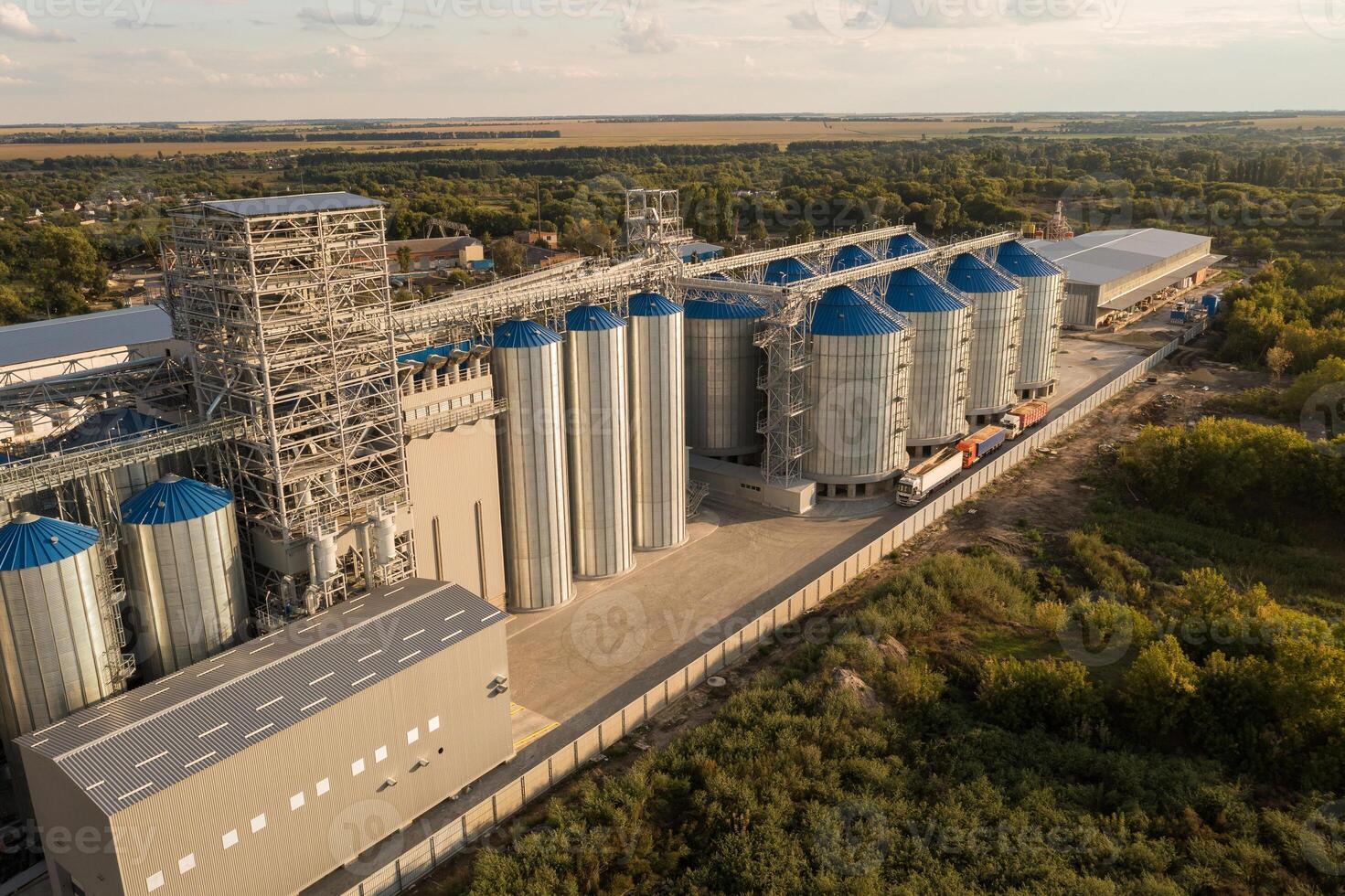 Aerial View of Modern Grain Elevator and Silos with Trucks in Rural Area Agricultural Infrastructure photo
